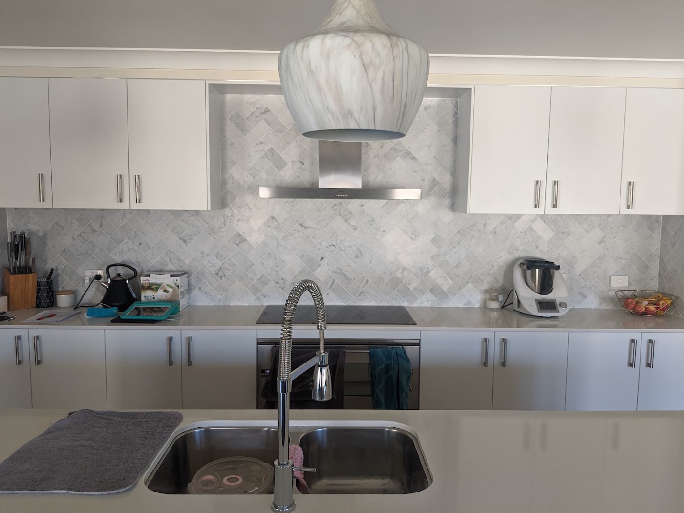 A patterned tile kitchen splashback above a benchtop