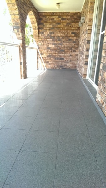 Tiled paving along a covered brick verandah